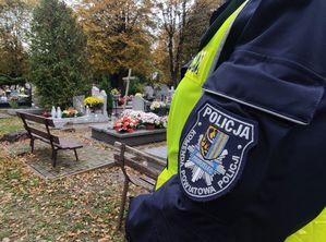 Na zdjeciu emblemat Komendy Powiatowej Policji w Zgorzelcu na tle cmentarza